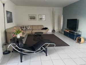ein Wohnzimmer mit einem Sofa und einem TV in der Unterkunft Apartment Residenza Canto Sereno by Interhome in Minusio