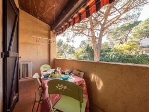 a table and chairs in a room with a window at Apartment Gigaro Plage by Interhome in La Croix-Valmer