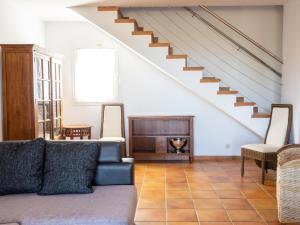 a living room with a couch and a staircase at Villa Villas Finesse Villas 3 dorm by Interhome in Son Bou