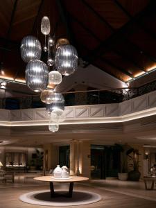 a lobby with a table and chandeliers at SH Villa Gadea in Altea