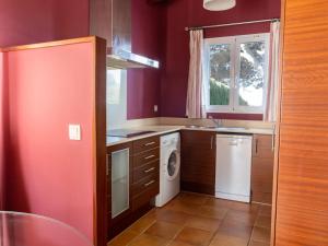 a kitchen with a sink and a washing machine at Villa Villas Finesse Villas 3 dorm by Interhome in Son Bou