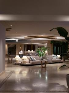 a large lobby with couches and tables in a building at SH Villa Gadea in Altea