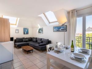 a living room with a couch and a table at Apartment Les Marines 1 et 2-7 by Interhome in Cabourg