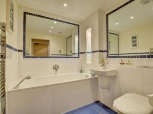 a bathroom with a tub and a sink and a toilet at Apartment Rockham by Interhome in Mortehoe