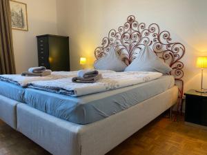 a bedroom with a large bed with a large headboard at Apartment App- Paradiso by Interhome in Paradiso