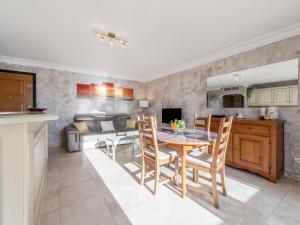 Una cocina y una sala de estar con mesa y sillas. en Apartment Le Domaine de la Baie-1 by Interhome, en Cavalaire-sur-Mer