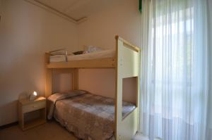 Ένα ή περισσότερα κρεβάτια σε δωμάτιο στο Appartamenti Acquaverde