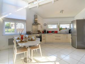 a kitchen with a table and a refrigerator at Holiday Home Ker Penthièvre by Interhome in Penthièvre