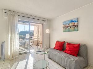 a living room with a couch and a glass table at Apartment Le Capitole-9 by Interhome in Fréjus