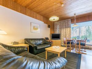 a living room with a leather couch and a table at Holiday Home Joutiainen l 69 in Hara
