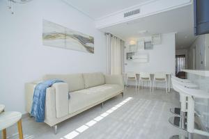a living room with a couch and a kitchen at 240 Lux Pool Home -Alicante Holiday in Torre de la Horadada