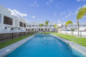 a swimming pool in front of a building at 240 Lux Pool Home -Alicante Holiday in Torre de la Horadada