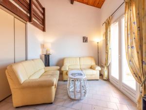 a living room with two couches and a table at Apartment Les Sauvagières II-5 by Interhome in Cavalaire-sur-Mer