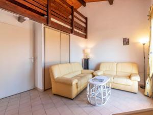 a living room with two couches and a table at Apartment Les Sauvagières II-5 by Interhome in Cavalaire-sur-Mer