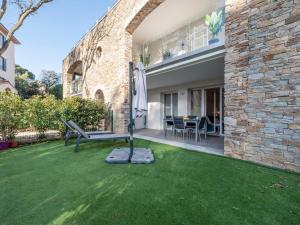 a patio with a bench and a table in a yard at Apartment Le Domaine-1 by Interhome in Cavalaire-sur-Mer