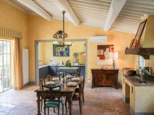 a dining room with a table and a kitchen at Villa Ghizzano by Interhome in Peccioli