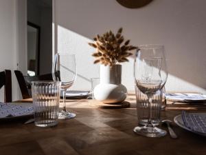 PirouにあるHoliday Home Les Chardons by Interhomeのグラスと花瓶が置かれた木製のテーブル