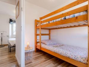 a bedroom with two bunk beds and a desk at Holiday Home Le Coquelicot by Interhome in Pirou +13 photos
