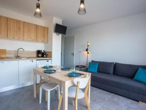 a living room with a table and a couch at Apartment Indigo Bay by Interhome in Le Lavandou