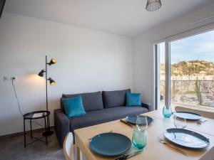 a living room with a table and a couch at Apartment Indigo Bay by Interhome in Le Lavandou