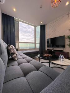 a living room with a couch and a large window at Almasarat Tower Sea View in Jeddah