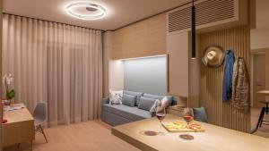a living room with a couch and a table at Appartamento AmaRèmin - Vivere Rimini in Rimini