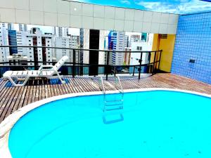 a swimming pool on the roof of a building at Flat Boa Viagem luxo in Recife