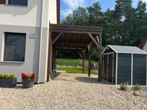 a building with a garage next to a house at Boya Home in Wilkasy