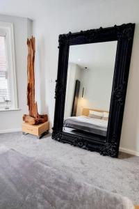 a bedroom with a large mirror and a bed at Stylish Flat in Bournemouth Town Centre in Bournemouth