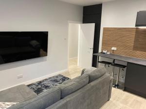a living room with a couch and a table at Stylish Flat in Bournemouth Town Centre in Bournemouth