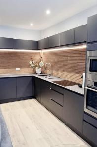 a kitchen with a sink and a microwave at Stylish Flat in Bournemouth Town Centre in Bournemouth