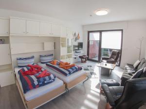 sala de estar con 2 camas y sofá en Ferienwohnung Emilia, FeWo Vermittlung Nordsee, en Dangast