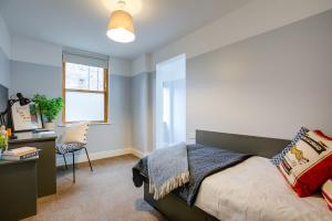 a bedroom with a bed and a desk and a window at Griffith Halls of Residence in Dublin