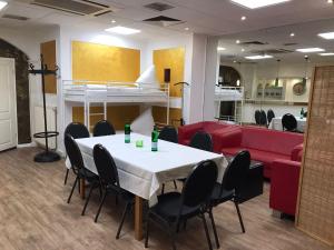 a room with a table and chairs and a loft bed at Hotel Glockengasse in Cologne