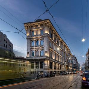 a tall building on a city street with cars at Radisson Collection Hotel, Palazzo Touring Club Milan in Milan