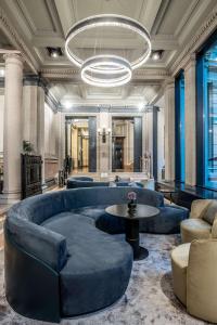 a lobby with a large blue couch and a table at Radisson Collection Hotel, Palazzo Touring Club Milan in Milan