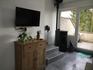 uma sala de estar com uma televisão de ecrã plano na parede em Les terrasses de Malmedy duplex 420 em Malmedy