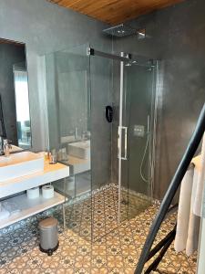 a bathroom with a glass shower and a sink at Hótel Kría in Vík