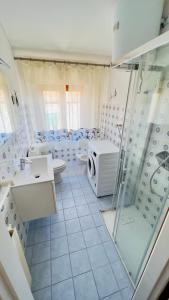 a bathroom with a shower and a toilet and a sink at Appartamenti Via Roma 41 in Campo nell'Elba