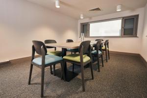 a conference room with a wooden table and chairs at Caban, Pendine Sands in Pendine