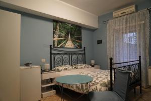 a bedroom with a bed with a table and a painting on the wall at Le Quattro Meraviglie in Rome