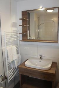 a bathroom with a sink and a mirror at LA2 f - Ferienreihenhaus LA2 in Schottwarden