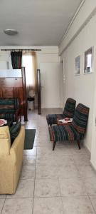 a living room with two couches and a table at Eleni-apartments in Thessaloniki