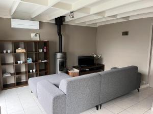 a living room with a couch and a stove at Nieuwendamme 88 in Nieuwpoort
