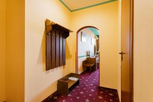 a hallway of a room with a mirror and a room with a sink at Tiso Apart Hotel in Kyiv