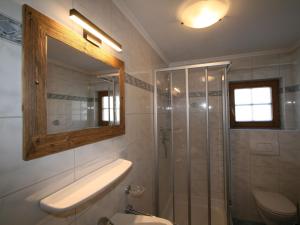 a bathroom with a shower and a sink and a mirror at Chalet Heisenhaushütte by Interhome in Ramsau im Zillertal