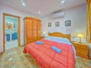 a bedroom with a large bed with two blue towels on it at Apartment Canuta Baja 7 by Interhome in Calpe