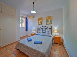 a bedroom with a bed with two blue towels on it at Apartment Canuta Baja 3 by Interhome in Calpe