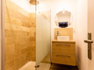 a bathroom with a shower with a sink and a mirror at Holiday Home Le Clos Renard by Interhome in Commes