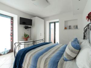 ein Schlafzimmer mit einem Bett und einem TV an der Wand in der Unterkunft Apartment A' Ca' de Alida by Interhome in Ortovero